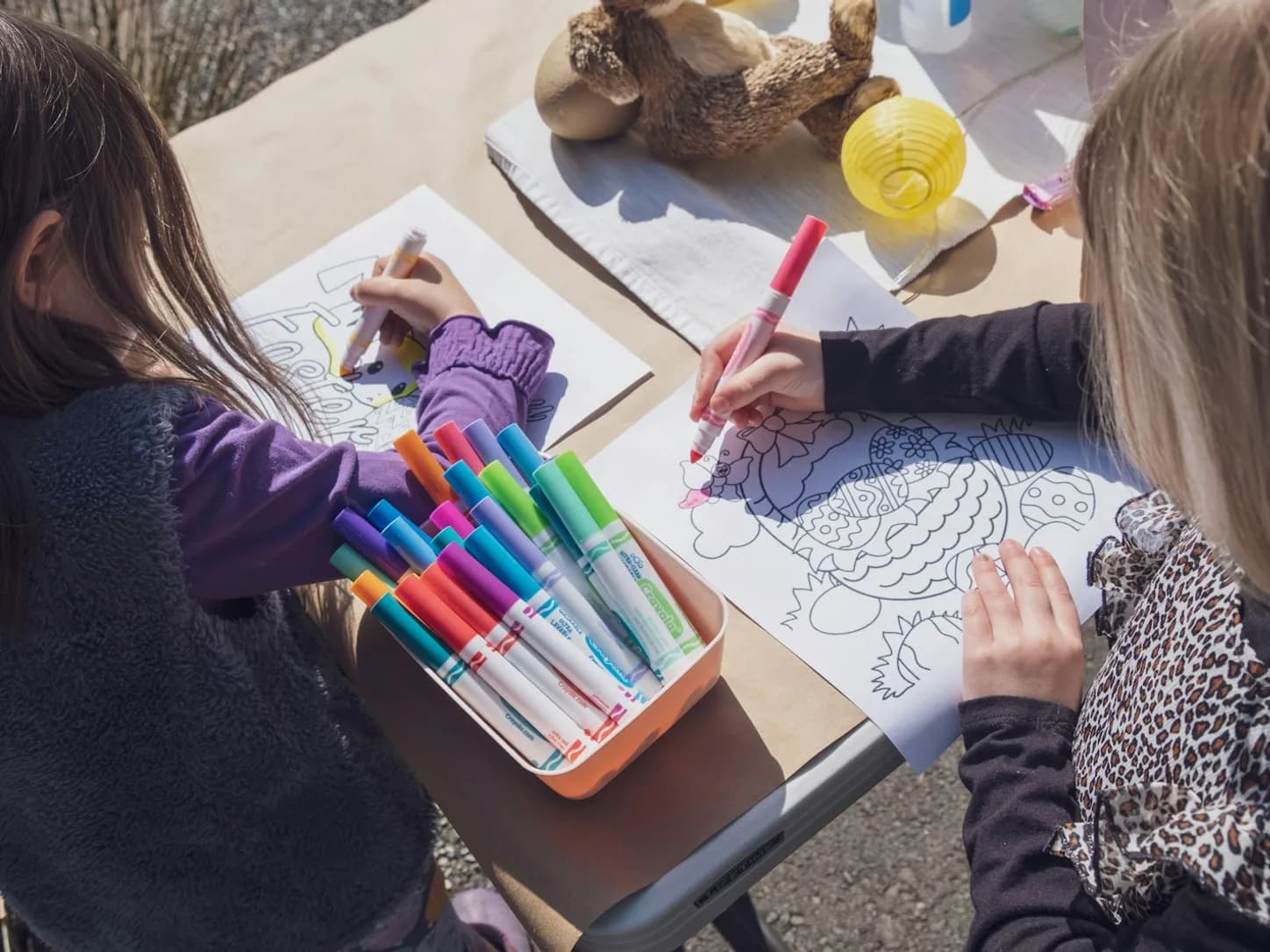 Children coloring together during a creative summer activity